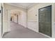Hallway boasts wainscoting, neutral color palette, and well-lit access to unit 2201 at 2201 Stratford Commons, Decatur, GA 30033