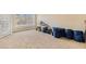 Spacious living room with large window, plush carpeting, and sliding glass door at 2201 Stratford Commons, Decatur, GA 30033