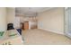 Open living room showing neutral walls and carpet, with view to kitchen at 2201 Stratford Commons, Decatur, GA 30033
