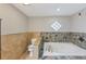 Bright bathroom featuring a jetted tub with stylish tile surround at 2236 Brannen Se Rd, Atlanta, GA 30316