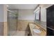 Well-lit bathroom with double sink vanity, granite countertops and glass shower at 2236 Brannen Se Rd, Atlanta, GA 30316