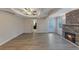 Open-concept living room with fireplace and plank flooring, with views of the kitchen at 2236 Brannen Se Rd, Atlanta, GA 30316
