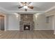 Spacious living room boasts a stone fireplace, modern lighting, and hardwood floors at 2236 Brannen Se Rd, Atlanta, GA 30316