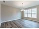 Open dining area features hardwood flooring, a chandelier, a large window with lots of light at 362 Pecan Ct, Mcdonough, GA 30252