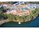 Aerial view of a community lake, construction, tennis courts, and walking paths at 1209 Lakeside Overlook, Canton, GA 30114