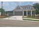 Charming home features a two-car garage, neutral siding, stone accents, and a well-manicured front lawn at 1209 Lakeside Overlook, Canton, GA 30114