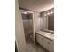Bathroom with a tub and shower, vanity with sink, and gray flooring at 1350 Cedars Rd, Lawrenceville, GA 30045