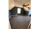 Spacious bedroom featuring neutral carpet, ceiling fan, and a window for natural light at 1350 Cedars Rd, Lawrenceville, GA 30045