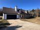 Exterior shot of home featuring attached garage, dormer windows, and front lawn at 1350 Cedars Rd, Lawrenceville, GA 30045