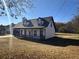 Charming two-story home with covered porch, dormer windows, and attached garage at 1350 Cedars Rd, Lawrenceville, GA 30045