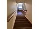 View of the staircase with a wooden handrail leading to the front door at 1350 Cedars Rd, Lawrenceville, GA 30045