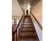 Staircase with wooden banister leading to the upper level, and neutral toned walls at 1350 Cedars Rd, Lawrenceville, GA 30045