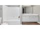 Bathroom with white tub and sink at 6422 Pinebark Way, Morrow, GA 30260
