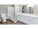 Bright bathroom with white cabinets and a large mirror at 6422 Pinebark Way, Morrow, GA 30260