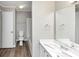 Clean bathroom with wood-look flooring and ample lighting at 6422 Pinebark Way, Morrow, GA 30260