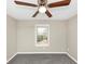 Cozy bedroom featuring a ceiling fan, a bright window, and neutral colored walls at 6422 Pinebark Way, Morrow, GA 30260