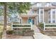 Charming townhome with a bright blue front door and a well-maintained white picket fence at 6422 Pinebark Way, Morrow, GA 30260