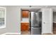 Compact kitchen featuring stainless steel refrigerator and ample storage space within wood cabinets at 6422 Pinebark Way, Morrow, GA 30260