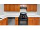 Modern kitchen with stainless steel dishwasher and oven, complemented by rich wood cabinetry at 6422 Pinebark Way, Morrow, GA 30260