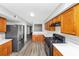 Functional kitchen layout with stainless steel appliances, granite countertops, and seamless cabinetry at 6422 Pinebark Way, Morrow, GA 30260