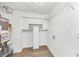 Neat laundry room with storage shelves, an efficient water heater, and modern flooring at 6422 Pinebark Way, Morrow, GA 30260
