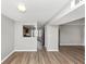 Open living room showcasing hardwood floors, neutral paint, and an open view of the modern kitchen at 6422 Pinebark Way, Morrow, GA 30260