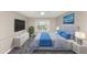 This bedroom features a tufted headboard, a large window, a ceiling fan, and an entertainment center at 6422 Pinebark Way, Morrow, GA 30260