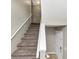 Carpeted staircase with white railing, leading to the upper level at 6422 Pinebark Way, Morrow, GA 30260