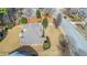 Aerial view of a property with a well-maintained yard, mature trees, and a neatly landscaped lawn at 1027 Eagles Brooke Dr, Locust Grove, GA 30248