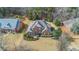 A high aerial view shows the home, well-maintained landscaping, and surrounding neighborhood at 1027 Eagles Brooke Dr, Locust Grove, GA 30248