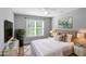 Comfortable bedroom with a large window, modern decor, and a relaxing ambiance at 1027 Eagles Brooke Dr, Locust Grove, GA 30248