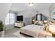Well-lit bedroom with a vaulted ceiling, large windows, and stylish decor at 1027 Eagles Brooke Dr, Locust Grove, GA 30248