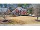 Charming two-story brick home with manicured lawn and beautiful landscaping at 1027 Eagles Brooke Dr, Locust Grove, GA 30248