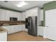 Bright kitchen with stainless steel appliances, white cabinets, and modern tile backsplash at 1027 Eagles Brooke Dr, Locust Grove, GA 30248