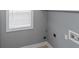Efficient laundry room featuring a window for natural light and essential utility connections at 1027 Eagles Brooke Dr, Locust Grove, GA 30248
