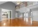 Spacious open-concept living area featuring hardwood floors and decorative pillars at 1027 Eagles Brooke Dr, Locust Grove, GA 30248