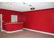 Basement featuring red walls, recessed lighting, and a red countertop bar at 145 Bridgewood Se Dr, Conyers, GA 30094