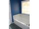 Bathroom highlighting a bathtub with a window for natural light at 145 Bridgewood Se Dr, Conyers, GA 30094