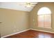 Bedroom features a vaulted ceiling, large arched window, and hardwood floors at 145 Bridgewood Se Dr, Conyers, GA 30094