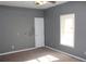 A gray bedroom with a window and ceiling fan at 145 Bridgewood Se Dr, Conyers, GA 30094