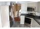 Bright kitchen with stainless steel appliances, mosaic backsplash, and light grey cabinetry at 145 Bridgewood Se Dr, Conyers, GA 30094