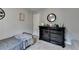 This bedroom features light grey walls and a dresser adorned with framed pictures at 2885 Green Rd, Loganville, GA 30052