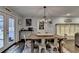 Dining room area with rustic table, chairs, decorative lighting, and doorway leading to outdoor patio at 2885 Green Rd, Loganville, GA 30052