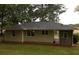 The back of the ranch-style home provides a view of the spacious backyard at 5901 Club Se Dr, Mableton, GA 30126