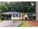 Charming ranch-style home featuring a carport and a welcoming red front door at 5901 Club Se Dr, Mableton, GA 30126