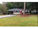 Inviting single-story home with an attached carport and mature landscaping at 5901 Club Se Dr, Mableton, GA 30126