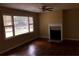 Bright living room featuring hardwood floors, a fireplace, and large windows at 5901 Club Se Dr, Mableton, GA 30126