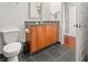 Modern bathroom features a wooden vanity with gray countertop at 1080 Peachtree Ne St # 2108, Atlanta, GA 30309