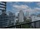 Stunning city view showcasing modern architecture, lush greenery, and clear blue skies from balcony at 1080 Peachtree Ne St # 2108, Atlanta, GA 30309