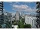 Spectacular city views featuring modern buildings, beautiful trees, and blue skies from condo at 1080 Peachtree Ne St # 2108, Atlanta, GA 30309